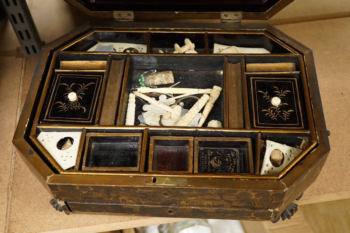 Three 19th-century Chinese gilt-decorated black lacquer sewing boxes, two containing bone sewing accessories, together with a similar tea chest (4) largest box- 33.3cm wide x 20cm high
